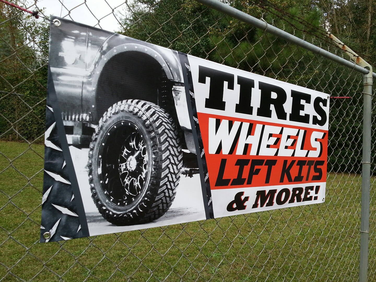 TIRES WHEELS LIFT KITS & MORE banner sign displays open auto repairs suspensions
